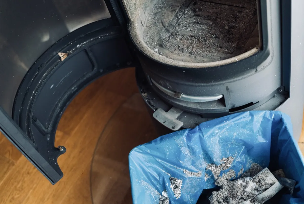 Gas insert with clean flames glowing behind sealed glass in a converted wood fireplace