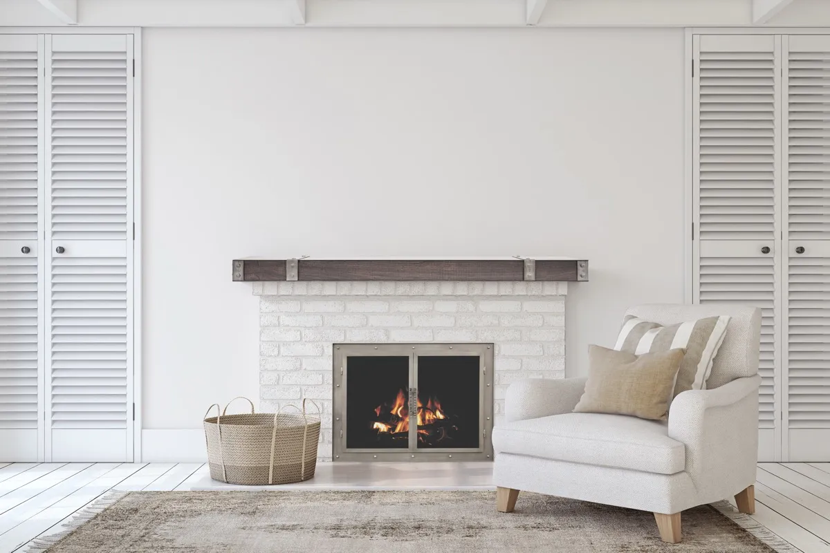 White brick fireplace with custom glass doors and rustic beam mantel in a bright living room