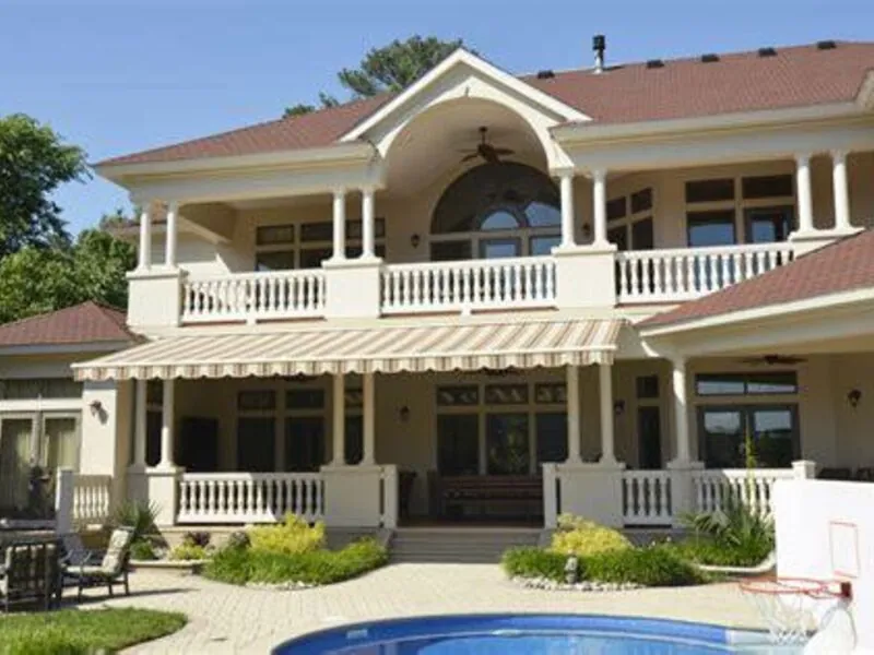 Aristocrat retractable awning shading a back deck on a sunny afternoon