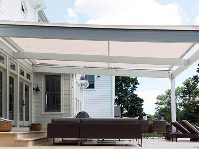 Aristocrat large tension shade over a backyard patio