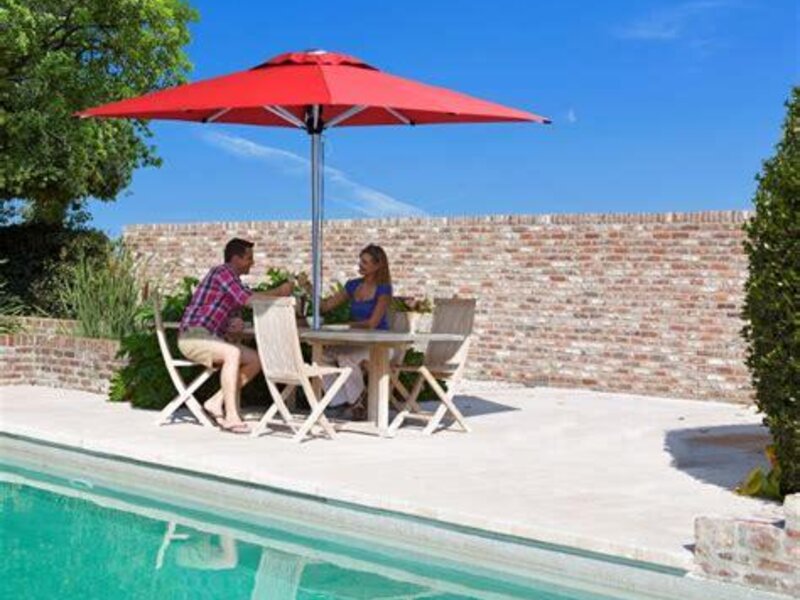 ShadowSpec Oasis single cantilever canopy over a poolside seating area — view 2