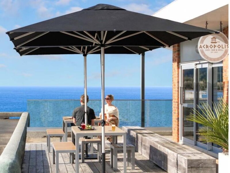 ShadowSpec Oasis single cantilever canopy over a poolside seating area