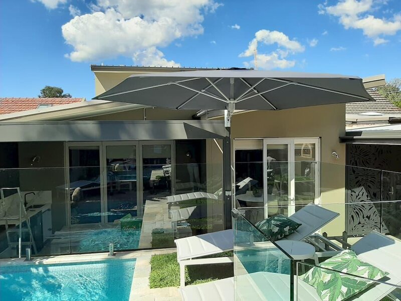 ShadowSpec Retreat single canopy shading a patio dining area — view 2
