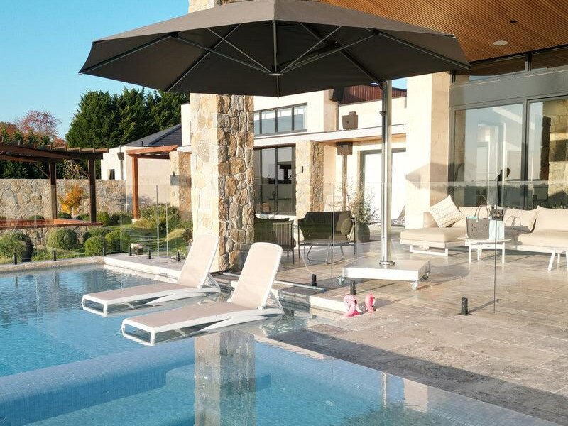 ShadowSpec Serenity single cantilever canopy shading an outdoor lounge — view 3