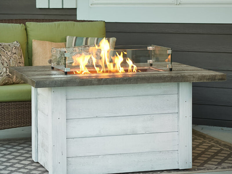Outdoor GreatRoom gas fire table with a cast top on a deck