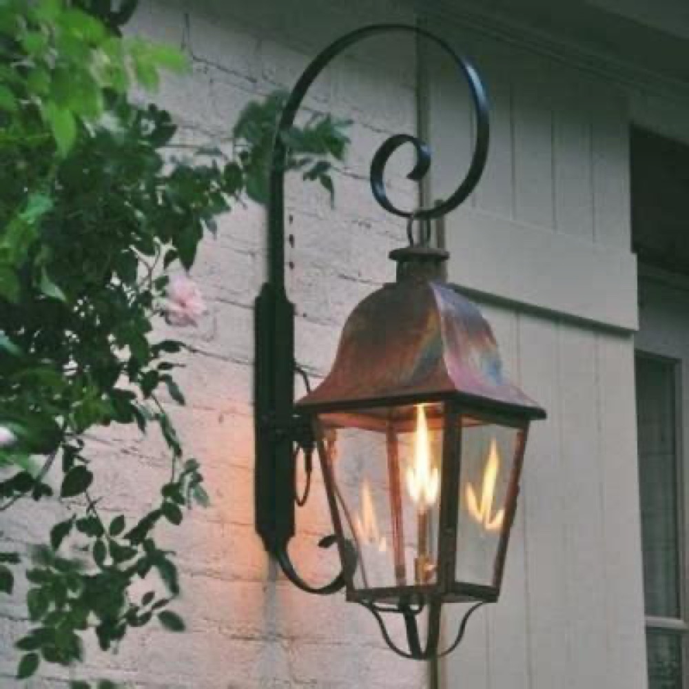 Legendary Lighting Apollo copper gas lantern on a stone wall — view 3