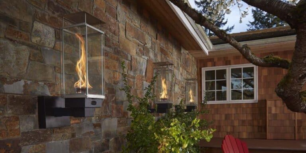 Fire Garden Tempest gas torch lit on a deck at dusk — view 3