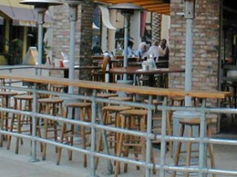 SunGlo overhead patio heaters warming an outdoor cafe seating area
