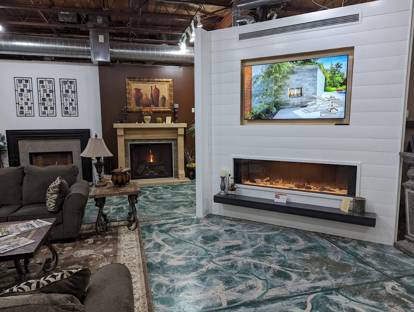 Inside the Alber's Fireplaces showroom with rows of burning fireplace displays